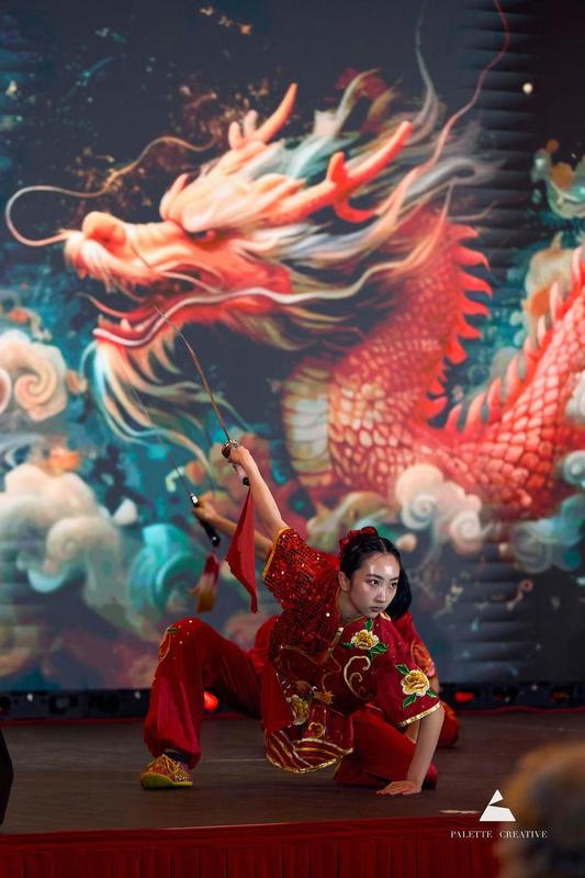 Performer in front of a painted dragon
